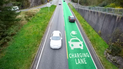 Road with one green electric vehicle charging lane