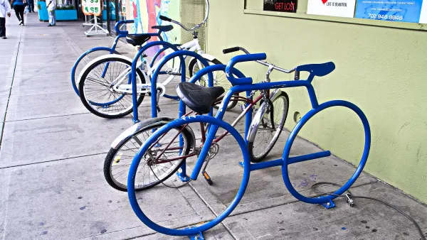 Blue bicycle-shaped bike racks on sidewalk in Las Vegas, Nevada.