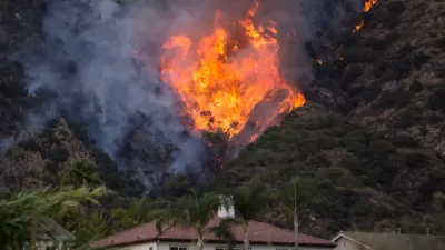 Fire burning on hillside behind house in Azusa, California
