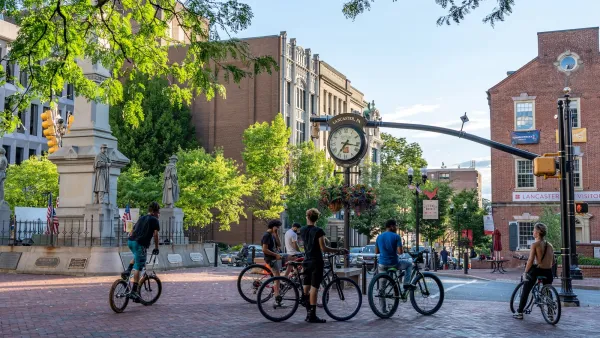 Group of teens with bikes stopped in public plaza in Lancaster, Pennsylvania.