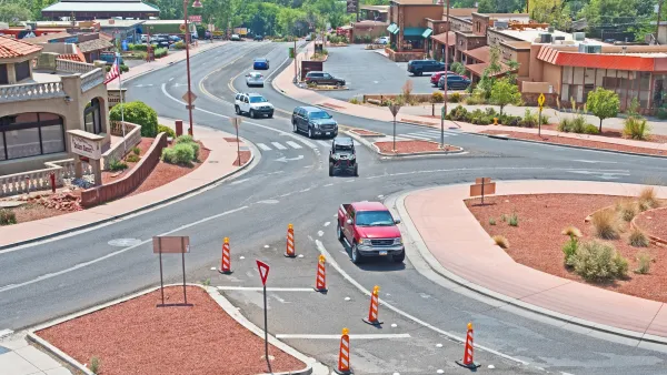 Roundabout with red mulch in middle in Sedona, Arizona with red truck driving through.