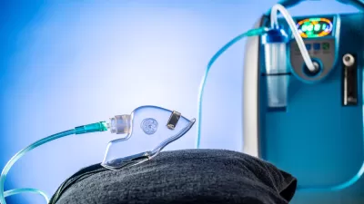 Blue portable oxygen medical device with attached clear mask