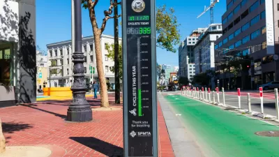 A bike counter next to a green protected bike lane in San Francisco, California