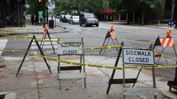 "Sidewalk Closed" signs on a-frames on roped-off sidewalk in Chicago.