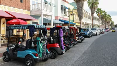 Line of colorful golf carts parked outside restaurant in The Villages, Florida