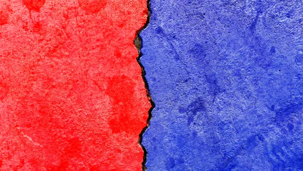 Concrete wall with crack running down the middle painted red on one side and blue on the other