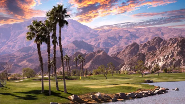 Golf course with palm trees and mountains in background in Palm Springs, California