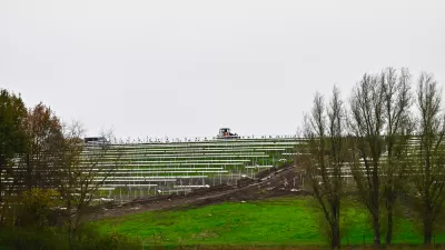 Solar panels on green inclined field on old landfill site in The Netherlands