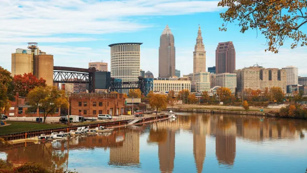 Skyline of Cleveland, Ohio with fall colors reflected in a river.