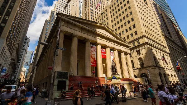 New York City, New York - July 29, 2016: View of the Federal Hall at 26 Wall Street in the Financial District with tourists walking on the street.