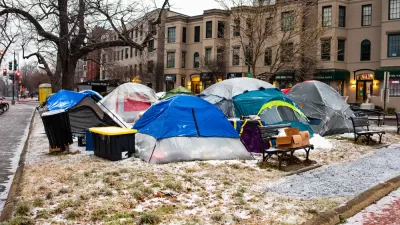 Group of tents and bins used by unhoused people in Washington, D.C. park with snow