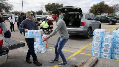 Volunteers wearing masks moving pallets of water bottles during February 2021 storm in Austin, Texas
