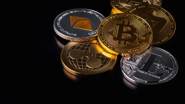 Loose, messy stack of silver and gold cryptocurrency coins with crypto logos.