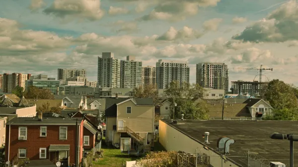 Skyline of Stamford, Connecticut with low-rise multifamily housing in foreground.