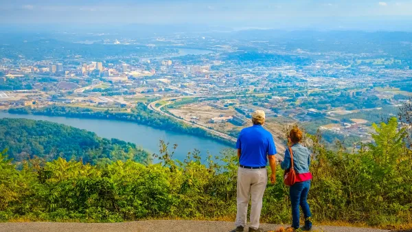 Couple seen from the back looking over Chattanooga, Tennessee from hilltop.