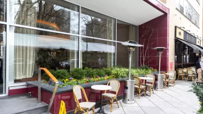 Empty chairs and tables on sidewalk at a Phialdelphia restaurant