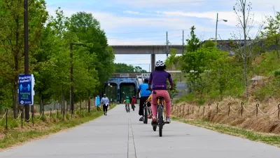 People on bikes ride along paved Atlanta BeltLine bike trail