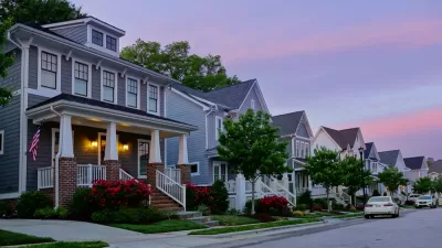 View of houses on small street in Raleigh, North Carolina against a sunset sky