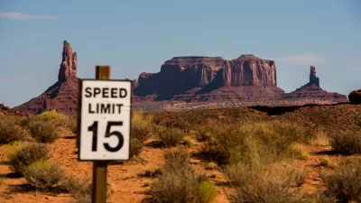 View of 15mph speed limit sign with Monument Valley mesas in the background