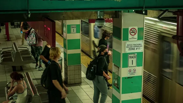 Crowded SEPTA subway station with people wearing masks waiting for train.