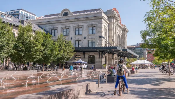 Cyclist paused in front of public water fountain in Denver, Colorado.