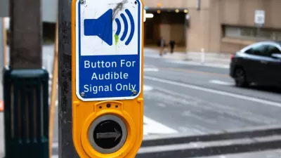 Close-up of crosswalk button for blind pedestrians labeled "button for audible signal only"
