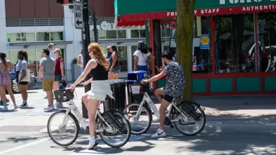 People riding electric bike share bikes in downtown Madison, Wisconsin
