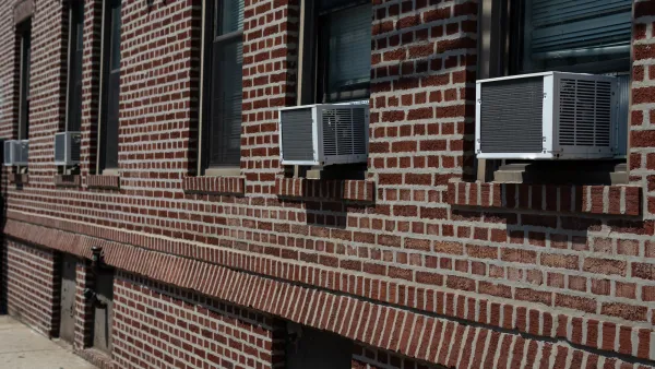 Window AC units on a brick building.