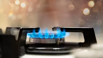 Close-up of lit burner on gas stove with blue flames