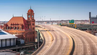 View of empty multi-lane freeway next to historic brick buildingin Richmond, Virginia