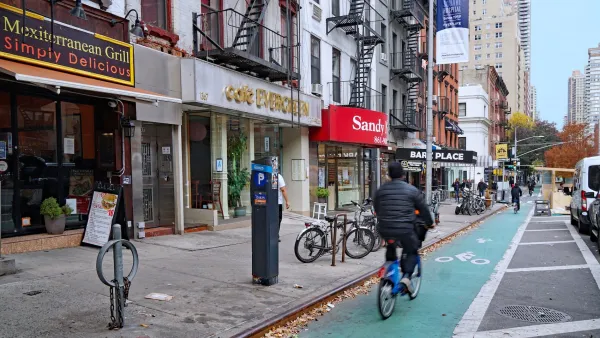 Person riding in green painted bike lane in New York City.