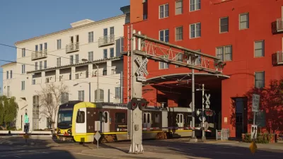 Light rail train passing under apartments in Pasadena, California