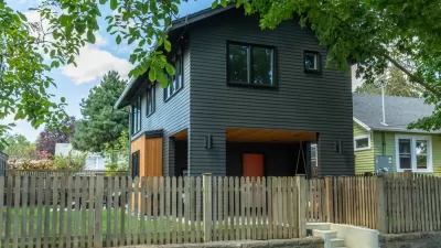 Dark grey two-story accessory dwelling unit in backyard