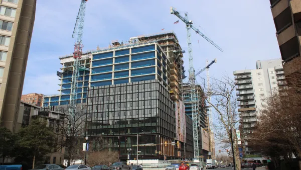 Amazon HQ2 building under construction with two large cranes over it in Pentagon City, Virginia.