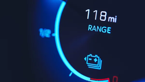 Close-up of car dashboard with 118 mi range.