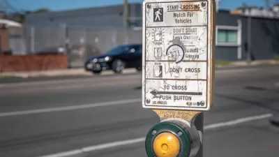 Close-up of pedestrian crossing button at a crosswalk in Los Angeles
