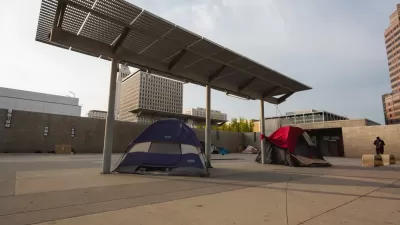 Unhoused tents under shade canopies in downtown Los Angeles, California