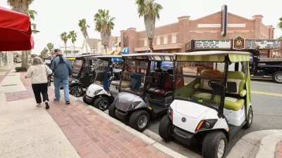Line of golf carts parked on street in The Villages, Florida