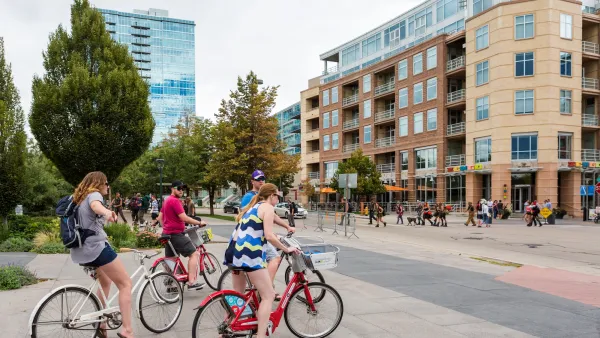 Group of people on bikes at intersection. in downtown, Denver. CO.