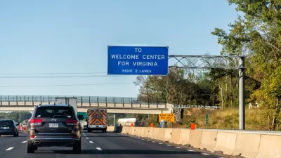 Interstate 95 near Fredericksburg, Virginia with blue sign that says "To Welcome Center for Virginia"