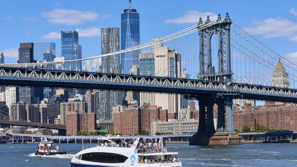 White and blue New York City ferry in river with Manhattan skyline in background.