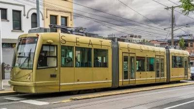 Gold Seattle Streetcar on street against stormy gray sky