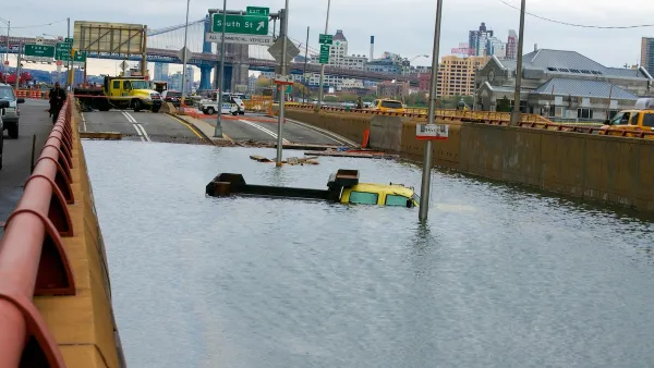 Flooded roadway with submerged cars after Hurricane Sandy in New York City.