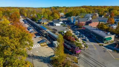 Aerial view of MBTA commuter rail station in Concord, Massachusetts among green trees