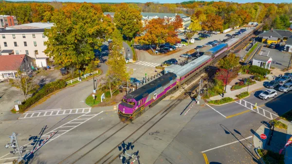 Aerial of purple train in station in small town Concord, Massachusetts.