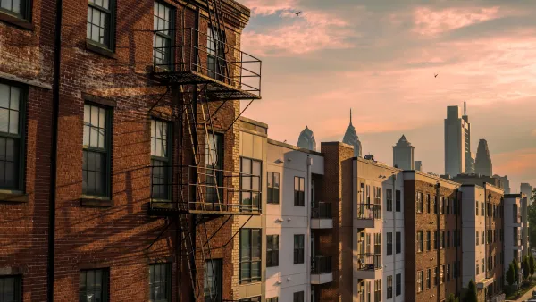 Brick apartment buildings with Phialdelphia skyline in the background.