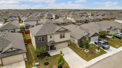 Low aerial view of two-story suburban Houston homes