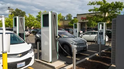 Electric car charging station with several Chevy Bolts charging in parking lot of store in Bellingham, Washington