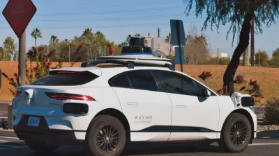 Self-driving white Waymo Jaguar SUV on street in Chandler, Arizona