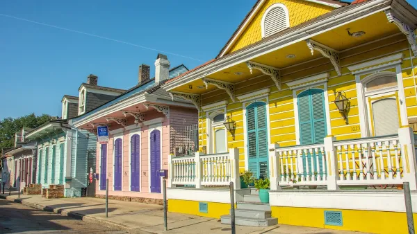 Bright yellow, pink, and green historic wooden houses in New Orleans, Louisiana.